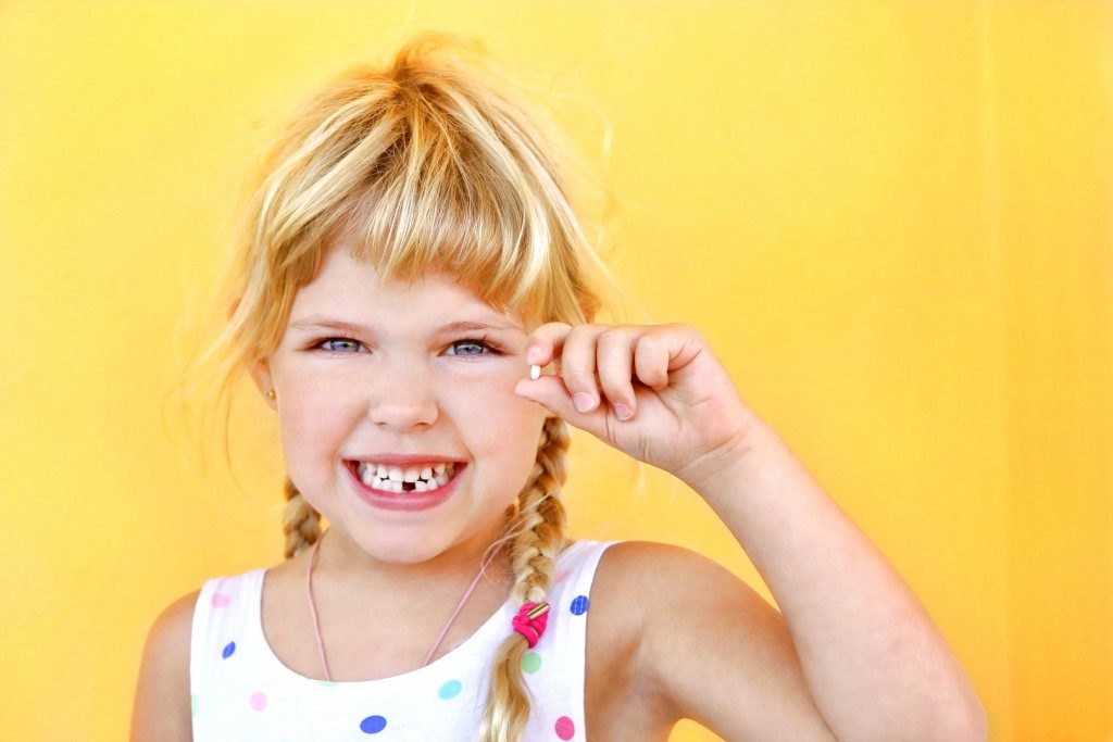 smiling girl with a lost tooth