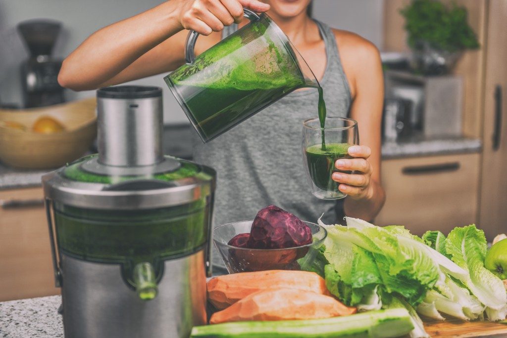 Woman pouring a healthy vegan juice