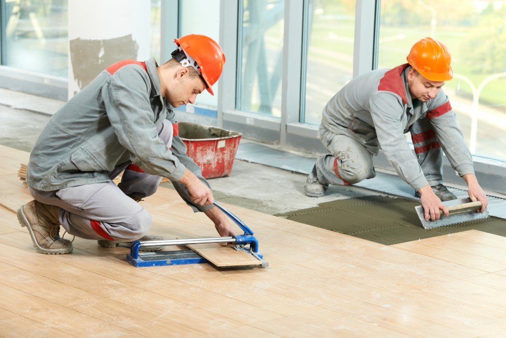 construction workers installing wood tiles