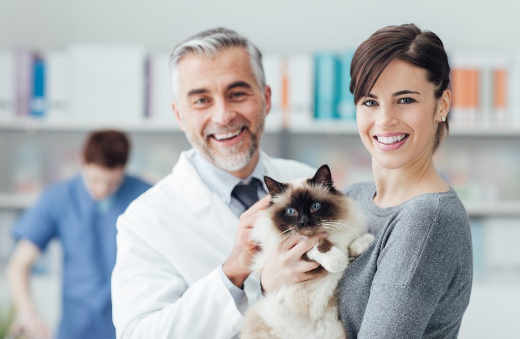 Vet with pet and owner