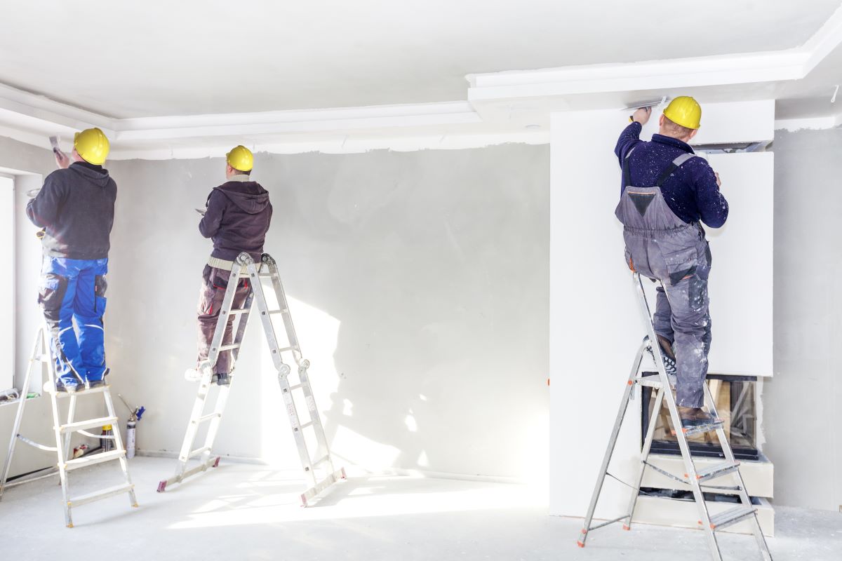 3 men painting a room