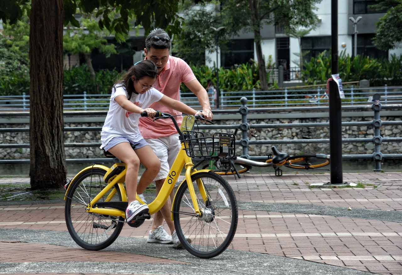 girl learning how to ride a bike