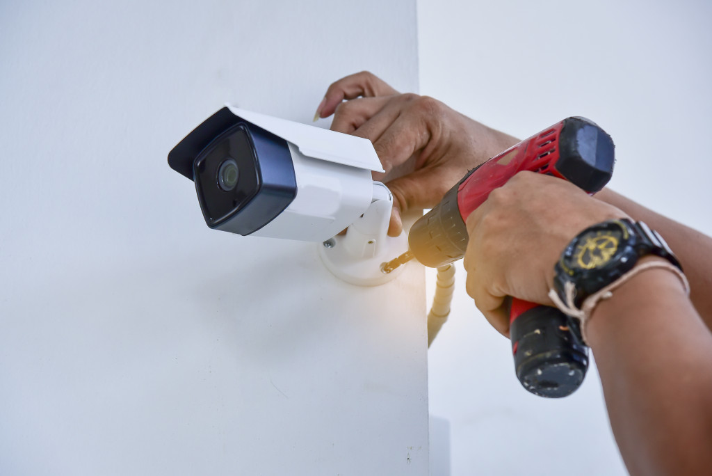 man installing security camera