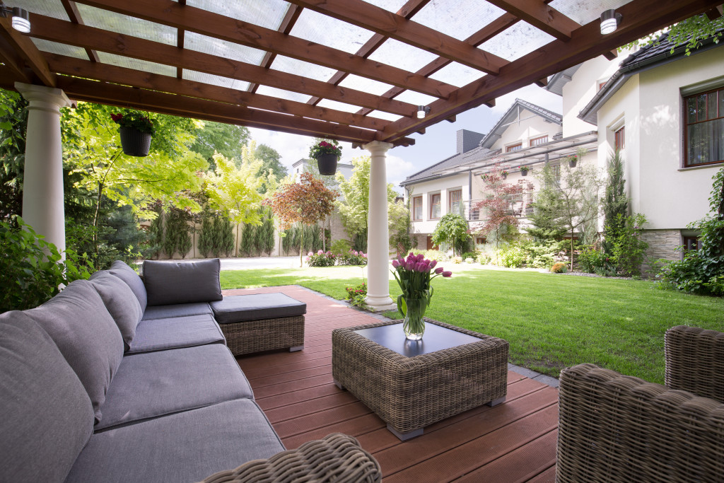 Focus on covered patio with the house in the background