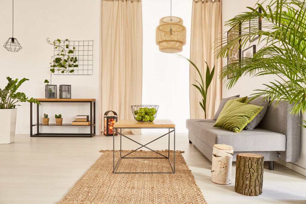 a living room decorated with green foliage