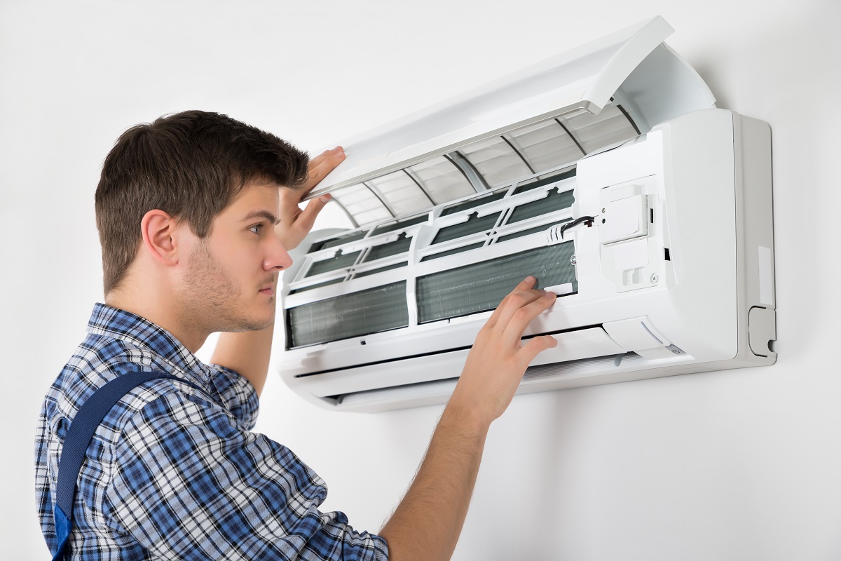 a man repairing air conditioning unit