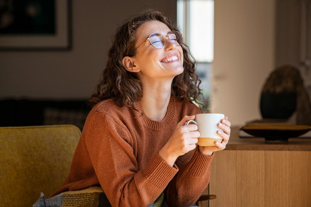 woman holding a cup smiling