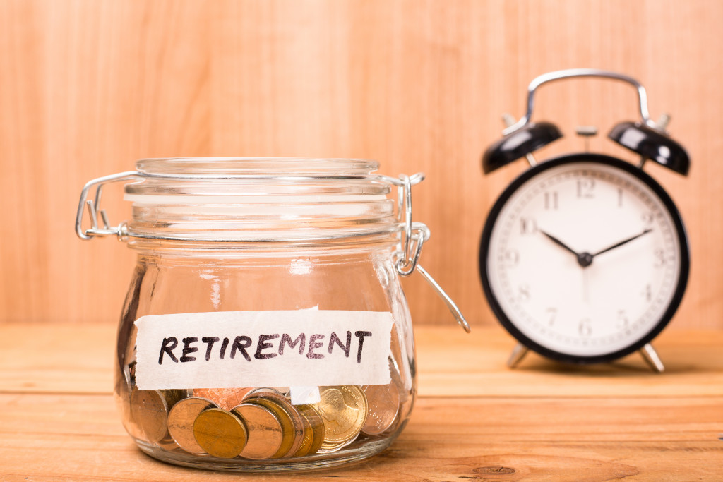 A jar with coins labeled with the word RETIREMENT