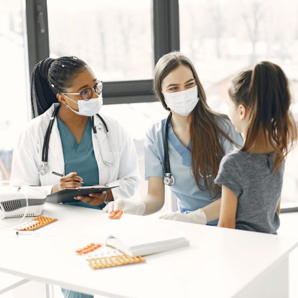 child being checked by doctors