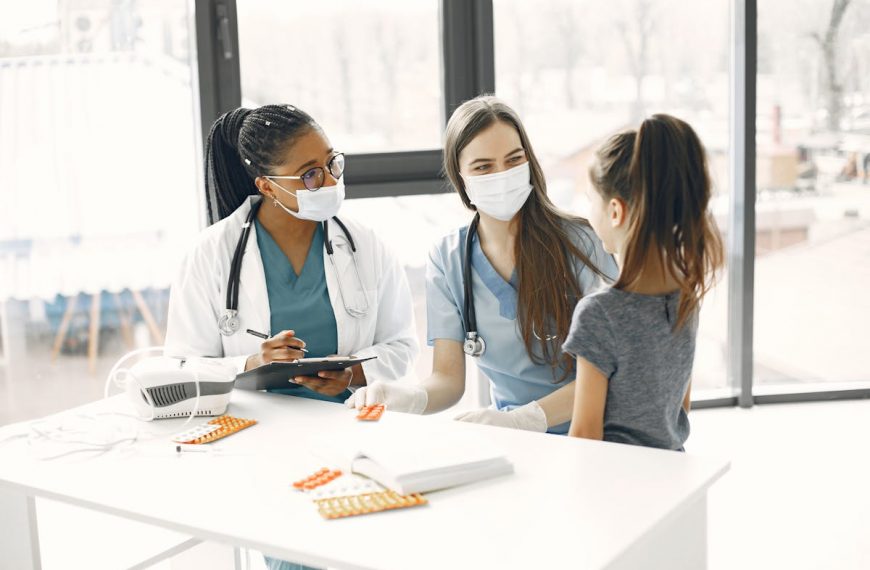 child being checked by doctors